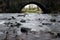 Smooth flowing stream beneath a bridge.  Pendleton brook in Clitheroe, Ribble valley