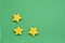 Smooth green single color abstract background with yellow stars on one side for card or web application