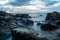 Smooth ocean during sunset at Koh Lanta with Stones in the sea and Phi Phi islands in the horizon, Koh Lanta, Thailand