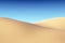 Smooth sand dunes with waves under blue sky