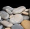 Smooth sea stones isolated on black closeup