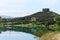 Smooth surface of Tbilisi reservoir water and hill with monument Chronicles of Georgia in morning