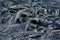 Smooth, undulating surface of frozen pahoehoe lava. Frozen lava wrinkled in tapestry-like folds and rolls resembling twisted rope