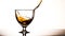 Smooth whiskey pouring into crystal wineglass, reflecting elegance and luxury generated by AI