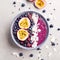 Smoothie acai bowl served in bowl on grey table