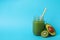 Smoothie, avocado and kiwi on blue background