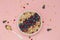 Smoothie bowl with blueberries, pomegranates and granola. Breakfast smoothie bowl on pink background, top view.
