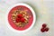 Smoothie bowl with raspberries, superfoods on white granite