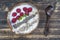 Smoothie in coconut bowl with raspberries, oatmeal, sunflower seeds and chia seeds for breakfast , close up. The concept of