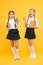 Smoothie detox. Yummy smoothie. Healthy nutrition. Schoolgirls holding juice bottle on yellow background. Quenching
