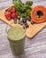 Smoothie fruits and kale in the background