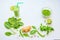 Smoothie in a glass and ingredients â€“ green peas, ginger, basil and spinach