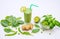 Smoothie in a glass and ingredients â€“ green peas, ginger, basil and spinach leaves