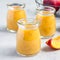 Smoothie with nectarine, orange juice, chia seeds and honey in glass jar, square format