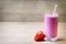 Smoothie, pink juice on the grey background.