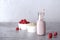 A smoothie with raspberries and oatmeal and milk stands on a gray background, there is a place to record