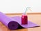 Smoothie and yoga mat on floor