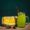 Smoothies from avocado, banana, mango, dill in glass and piece of durian on the table, morning light, close up