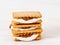 Smores, marshmallow sandwiches - traditional American sweet chocolate cookies on white wooden table, side view