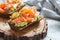 Smorrebrod with salmon on rye bread with vegetables and herbs