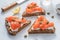 Smorrebrod, traditional Danish open sanwiches, dark rye bread with salmon, cream cheese and capers.