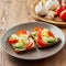 Smorrebrod - traditional Danish sandwiches. Black rye bread with boiled egg, cream cheese, cucumber, tomatoes on dark brown wooden