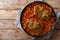 Smothered food Swiss steak in a spicy tomato sauce with vegetables close-up. horizontal top view