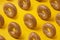 Snack bagel with sesame seeds on yellow background