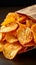 Snack indulgence Spicy BBQ potato chips, thin slices in open bag
