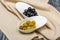 Snack of olives and olives in white porcelain bowls in restaurant