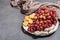 Snack plate with cheese, grapes and dried sausages. Charcuterie antipasto, stone concrete background