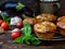 Snack savory muffins cakes with eggplant, tomatoes, basil and cheese on wooden background.
