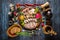 Snack set. Assorted sliced meat with spices on rustic wooden backgroundS