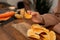 Snacking moment: individual choosing a potato chip from many on a table.