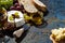 snacks, glass of wine and Camembert cheese on a dark background