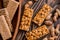 Snacks - mix of energy bars with peanut, sesame and sunflower seeds on a wooden background. Nuts in caramel, honey Snack food. Unh