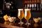 Snacks in pub on wooden bar. Two glasses with beer, chips, nuts and pistachios