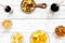 Snacks for TV watching. Chips, nuts, soda, rusks, dried fruits on white wooden background top view copy space