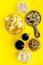 Snacks for TV watching. Chips, nuts, soda, rusks, dried fruits on yellow background top view copy space