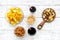 Snacks for TV watching. Chips, nuts, soda, rusks on white wooden background top view
