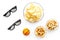 Snacks for watching sport matches and games on TV. Popcorn, rusks near glasses and ball on white background top view