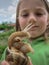 Snail closeup on the background of the face of the child..