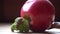 Snail crawls over the red apple and green broccoli, cute animal, film background