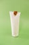 Snail extract.Snails on a white tube on a green background.Organic cosmetics with snail slime.Cosmetic tube with snail
