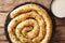 Snail pie borek burek from filo pastry with feta cheese closeup. Horizontal top view