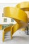 snail-shaped concrete exterior stairs painted in gold