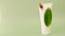 Snail slime.Snail on a white tube and a green leaf on a green background. Snail mucin.Snail extract.Cosmetic tube