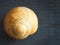 Snail spiral shell on wooden background.