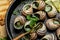 Snails baked with sauce, Bourgogne Escargot Snails. Baked snails with butter and spice. gourmet food. recipe background. Close up