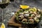 Snails baked with sauce, Bourgogne Escargot Snails. Baked snails with butter and spice. gourmet food. recipe background. Close up